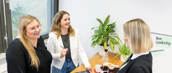 Drei Trainerinnen von Carpe verba! konzipieren gemeinsam am Tisch ein offenes Seminar für Einzelbucher.