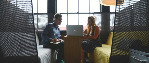 Zwei Personen im Coaching- und Sparring-Gespräch in einem modernen Büro – symbolisiert kreative Zusammenarbeit, persönliches Wachstum und Zielorientierung.